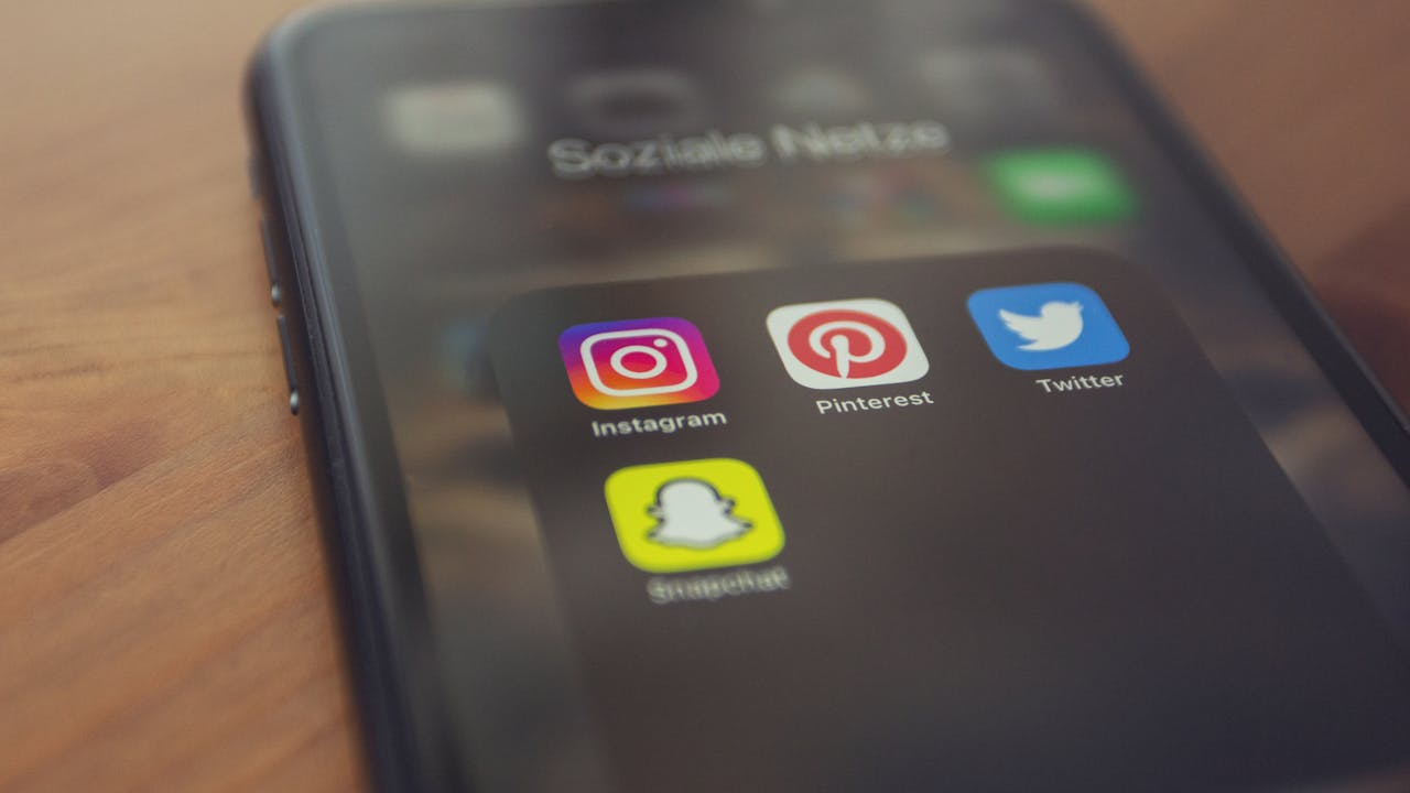 A hand holding a press pass with a QR code on it.